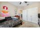 Bedroom with a dark-colored bed, view into bathroom, and minimalist decor at 1340 Bayshore Blvd # 411, Dunedin, FL 34698