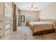 Bright bedroom featuring a large bed, ceiling fan, closet, and natural light at 1340 Bayshore Blvd # 411, Dunedin, FL 34698