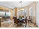 Bright dining area with ample natural light, a modern chandelier, and stainless steel refrigerator at 1340 Bayshore Blvd # 411, Dunedin, FL 34698