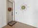 Front doorway with floral wreath, sun decoration, welcome mat, and sidelight at 1340 Bayshore Blvd # 411, Dunedin, FL 34698
