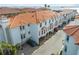 Aerial view of the exterior showcasing the architecture, tiled roof, and convenient parking at 1340 Bayshore Blvd # 411, Dunedin, FL 34698