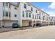 Townhouse exterior featuring multiple garages, beautiful architecture, and well-maintained landscaping for curb appeal at 1340 Bayshore Blvd # 411, Dunedin, FL 34698