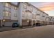 Townhome exterior featuring attached garages, stucco facade, and sunset sky at 1340 Bayshore Blvd # 411, Dunedin, FL 34698