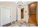 Foyer with tile flooring, elevator access, staircase, and decorative lighting at 1340 Bayshore Blvd # 411, Dunedin, FL 34698