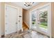 Foyer with tile flooring, staircase, elevator access, and decorative lighting at 1340 Bayshore Blvd # 411, Dunedin, FL 34698