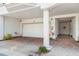 Attached garage with brick-paved driveway and adjacent walkway to a doorway at 1340 Bayshore Blvd # 411, Dunedin, FL 34698