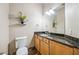 Well-lit half bathroom with granite countertops and decorative wall accents at 1340 Bayshore Blvd # 411, Dunedin, FL 34698