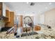 Gourmet kitchen featuring granite countertops, modern appliances, and a view to the dining area at 1340 Bayshore Blvd # 411, Dunedin, FL 34698