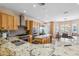 Gourmet kitchen with granite countertops, stainless steel appliances, custom cabinets, and a breakfast nook at 1340 Bayshore Blvd # 411, Dunedin, FL 34698