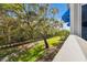 Beautiful view from the balcony overlooking lush landscaping, a walking path, and mature trees at 1340 Bayshore Blvd # 411, Dunedin, FL 34698