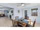 Bright dining area next to kitchen has a ceiling fan, table set for four, and modern appliances visible at 13632 Britton Dr, Hudson, FL 34667