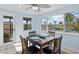 Cozy dining area features a ceiling fan, table set for four, and a window with a pleasant outdoor view at 13632 Britton Dr, Hudson, FL 34667