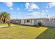 Charming single-story home features a well-maintained lawn, mature tree, and a cozy, inviting facade at 13632 Britton Dr, Hudson, FL 34667