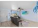 Cozy living room with ceiling fan features light-colored walls, wood-look floors, and comfortable seating at 13632 Britton Dr, Hudson, FL 34667