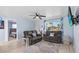 Inviting living room with light-colored walls, wood-look floors, comfortable seating, and adjacent bedroom at 13632 Britton Dr, Hudson, FL 34667