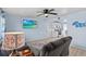 Comfortable living room features light-colored walls and wood-look floors flowing into the eat-in kitchen at 13632 Britton Dr, Hudson, FL 34667