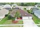 Aerial image of a well-manicured lawn and landscaping surrounding a single story home in a suburban neighborhood at 13942 Talmage Loop, Hudson, FL 34667