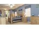 Cozy bedroom with soft lighting and stylish decor featuring blue walls, plush carpeting and coordinated furnishings at 13942 Talmage Loop, Hudson, FL 34667
