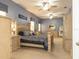 Spacious bedroom features plush carpet, blue walls, multiple ceiling fans, and a well-lit, ample vanity area at 13942 Talmage Loop, Hudson, FL 34667