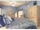 Well-lit bedroom with plush bedding, ample natural light, a large wood armoire, and neutral carpeting at 13942 Talmage Loop, Hudson, FL 34667