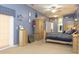 A blue bedroom features light wood furniture and decor, large windows, and plush carpeting throughout at 13942 Talmage Loop, Hudson, FL 34667
