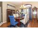 Elegant dining room featuring a modern chandelier, stylish furniture, and ample natural light at 13942 Talmage Loop, Hudson, FL 34667