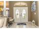 Bright foyer featuring double doors with decorative glass inlays and neutral decor at 13942 Talmage Loop, Hudson, FL 34667