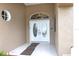 Close up of the exterior of the home's double front doors beneath an arched transom window at 13942 Talmage Loop, Hudson, FL 34667