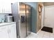 Modern kitchen with stainless steel refrigerator and white cabinets at 13942 Talmage Loop, Hudson, FL 34667