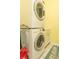Functional laundry room featuring a stacked washer and dryer unit at 13942 Talmage Loop, Hudson, FL 34667