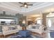 Bright and open living area with hardwood floors and easy access to the kitchen at 13942 Talmage Loop, Hudson, FL 34667