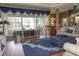 Comfortable living room showcasing an area rug, large window, and easy access to the lanai at 13942 Talmage Loop, Hudson, FL 34667