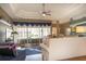 Inviting living room with a tray ceiling, view to the lanai, and comfortable seating at 13942 Talmage Loop, Hudson, FL 34667
