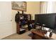 Bright office space featuring a large monitor, bookcase, and natural light at 13942 Talmage Loop, Hudson, FL 34667