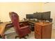 Home office featuring a wooden desk, executive chair and multiple computer monitors at 13942 Talmage Loop, Hudson, FL 34667