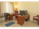 Home office featuring a wooden desk, executive chair, computer monitors and printer at 13942 Talmage Loop, Hudson, FL 34667