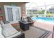 Relaxing covered patio with comfortable seating and pool view at 13942 Talmage Loop, Hudson, FL 34667