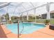 This backyard boasts an in-ground pool with blue tile and cool decking at 13942 Talmage Loop, Hudson, FL 34667
