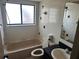 Cozy bathroom showcasing a tub, toilet, sink, and framed mirror at 1412 Wexford N Dr, Palm Harbor, FL 34683