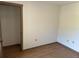 Bedroom with wood floor, closet, and window allowing natural light at 1412 Wexford N Dr, Palm Harbor, FL 34683