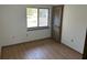 Bedroom with wood floor, closet with wooden door, and bright window at 1412 Wexford N Dr, Palm Harbor, FL 34683