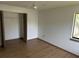 Bedroom featuring wood floor, ceiling fan, closet, and window allowing natural light at 1412 Wexford N Dr, Palm Harbor, FL 34683