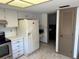 Cozy kitchen includes a refrigerator with an ice dispenser and nearby laundry room access at 1412 Wexford N Dr, Palm Harbor, FL 34683