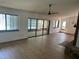 Open living room with fireplace, hardwood floor, ceiling fan, and view of pool at 1412 Wexford N Dr, Palm Harbor, FL 34683