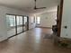Living room with fireplace, hardwood floor, ceiling fan and sliding glass doors at 1412 Wexford N Dr, Palm Harbor, FL 34683
