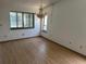 Living room with hardwood floor, chandelier, and bright windows for natural light at 1412 Wexford N Dr, Palm Harbor, FL 34683