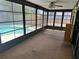 Relaxing sunroom provides a view of the inviting backyard pool and outdoor space at 1412 Wexford N Dr, Palm Harbor, FL 34683