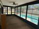 Enclosed sunroom offers views of the in-ground swimming pool and backyard at 1412 Wexford N Dr, Palm Harbor, FL 34683