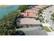 Lovely home with a well-maintained roof, mature landscaping, and a serene lake view in a quiet neighborhood at 15038 Tamarind Loop, Spring Hill, FL 34609