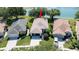 An aerial view of the house showcasing its proximity to a tranquil lake and beautifully landscaped surroundings at 15038 Tamarind Loop, Spring Hill, FL 34609